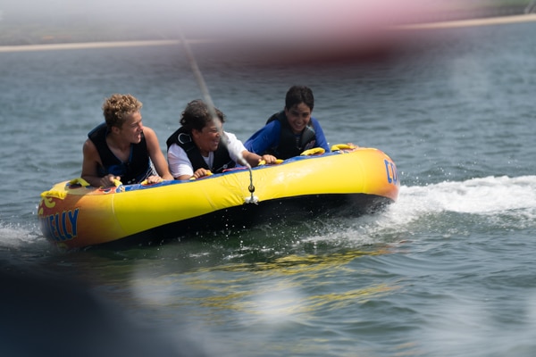 3 Kids Enjoying Peconic Water Sports 2024 Kids Camp from the back of a tube. In 2024 Peconic Water Sports will be offering kids camp at 4 locations on Long Islands east End both on the North and South Fork. Locations where kids camps are offered include Montauk, Southold, Shelter Island, Downtown Sag Harbor. Are your kids interested in fishing? Check out our customizable fishing camps!